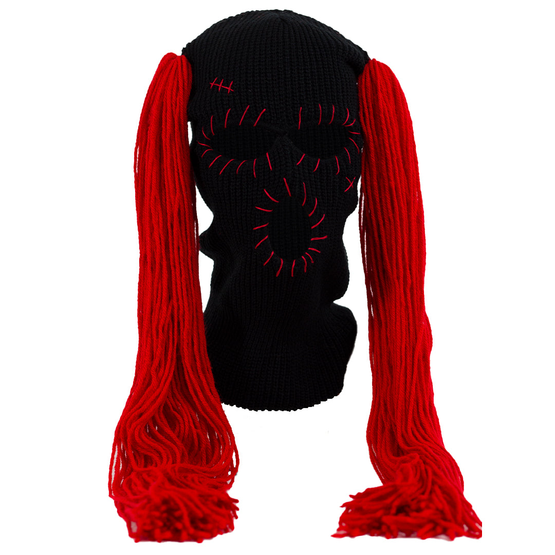 Black ski mask with red hair extensions on a white background